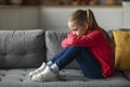 Depression In Children. Upset Little Girl Sitting On Couch At Home Royalty Free Stock Photo