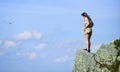 Depression concept. Brave woman stand alone in high mountains blue sky background. Soldier girl. Military female Royalty Free Stock Photo