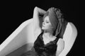 Depression concept. Sad woman in bath. Sadness, grief, frustration. Alone upset girl. Royalty Free Stock Photo