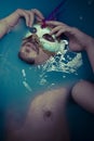 Depression, man in blue tub full of water, sadness concept Royalty Free Stock Photo