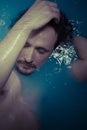 Depression, man in blue tub full of water, sadness concept Royalty Free Stock Photo