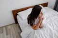 Depression and psychological problems, upset young millennial lady sit in bed alone feel stress anxiety after bad sleep