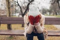 Depression. Sad young woman sitting on bench in autumn park crying covering face with hands. Mental health Royalty Free Stock Photo