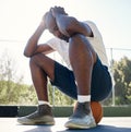 Depression, sport and man on basketball court for fitness outdoors. Stressed black athlete, mental health and tired Royalty Free Stock Photo