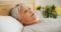 Depression, tired and an elderly woman in bed for peaceful rest or to relax in her retirement home closeup. Face Royalty Free Stock Photo