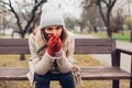 Depression. Woman in trouble sitting on bench in autumn park covering face with hands. Mental health Royalty Free Stock Photo