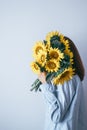 Depression women hide their faces behind yellow flowers Royalty Free Stock Photo