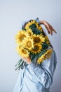 Depression women hide their faces behind yellow flowers Royalty Free Stock Photo