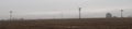 Depressive, ghostlike and foggy winters day in Czech countryside. Meadow with electric posts in the fog