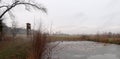 Depressive, ghostlike and foggy winters day in Czech nature. Panorama of a meadow with frosted pond in the foreground Royalty Free Stock Photo