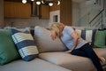 Woman lying at the table, depressed, lonely, sick, despondent, unhappy, suffering, among pills