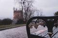 A depth of field shot of ornate decorated leaves on a park bench, With a priory in the background, Malvern, Worcestershire, UK Royalty Free Stock Photo