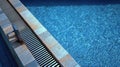 Depth Markers and Tiles Along a Clear Poolside Edge Reflect Sunlight on a Summer Day Royalty Free Stock Photo