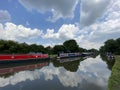 Canal Boats at Willington, Derbyshire. Cloudy sky reflected in the water.