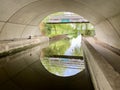 Derby, UK, June 21, 2021. Canal under modern bridge, Mercia Marina, Derbyshire. Royalty Free Stock Photo