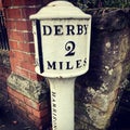 Derby, UK, 2020. Vintage Road Milage sign, Derby 2 Miles. Derby, England