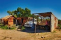 Derelict abandoned farm buildings and an old truck in the desert of South Australia