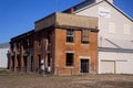 Derelict abandoned old brick building and new warehouse