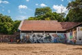 Derelict building with young Brazilian boy kicking a football near Ponta Negra beach in Manaus, Amazon, Brazil