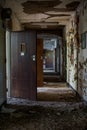 Derelict Hallway with Open Wood Doors - Abandoned Rockland State Hospital - New York Royalty Free Stock Photo