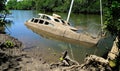 Derelict partially sunken boat in a creek