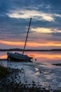 Derelict sailboat against colorful sunset