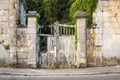 Derelict wooden gate in an old textured stone wall. Royalty Free Stock Photo