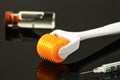 Derma roller for medical micro needling therapy with syringe and vial Royalty Free Stock Photo