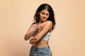 Dermatitis, eczema, allergy, psoriasis concept. Annoyed young indian woman scratching irritated skin Royalty Free Stock Photo