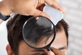 Dermatologist Checking Patient`s Hair With Magnifying Glass Royalty Free Stock Photo