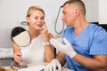Dermatologist is consulting to female patient about her skin of face Royalty Free Stock Photo