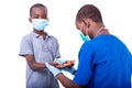 A dermatologist doctor examining the hands of a little boy Royalty Free Stock Photo