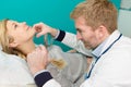 Dermatologist examining mole with magnifying glass in clinic Royalty Free Stock Photo