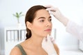 Dermatologist examining patient`s face in clinic. Royalty Free Stock Photo