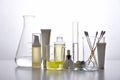 Dermatologist formulating and mixing pharmaceutical skincare, Cosmetic bottle containers and scientific glassware.