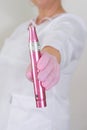 Dermatologist Holding a Pink Dermapen