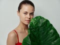dermatology beautiful woman with palm leaf and red t-shirt