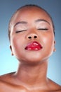 Dermatology, beauty and black woman with makeup, cosmetics and gloss on a blue studio background. Luxury, African person