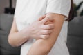 Dermatology concept. Close up of young woman suffering allergic reaction from atopic, insect bites on her arm, hand in scratching Royalty Free Stock Photo