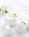 Dermatology herbal cosmetic cream with flowers hygienic skincare product Royalty Free Stock Photo