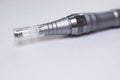 Dermis stamp electric pen. Dermapen. Needle mesotherapy treatment.