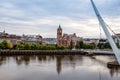 Derry, Ireland. Illuminated Peace bridge in Derry Londonderry, City of Culture, in Northern Ireland with city center at Royalty Free Stock Photo