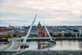 Derry, Ireland. Illuminated Peace bridge in Derry Londonderry, City of Culture, in Northern Ireland with city center at Royalty Free Stock Photo