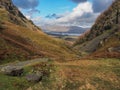 Derwent Water from path in a steep valley with sun on the fells, Lake District Royalty Free Stock Photo