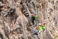 Young Group Of Climbers Climbing A Rock Wall