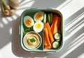 Healthy Lunchbox with Hummus, Eggs, and Veggies Royalty Free Stock Photo