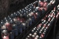 Desaturated closeup of colorful candles burning in the tunnel of Covadonga, Cangas de Onis, Asturias, Spain. Spirituality Royalty Free Stock Photo