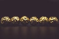 Desaturated golden Christmas baubles on black background. Royalty Free Stock Photo