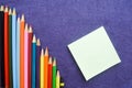 A descending chart of colorful, bright, variegated drawing pencils, a notebook Royalty Free Stock Photo