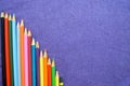 A descending chart of colorful, bright, variegated drawing pencils, a notebook Royalty Free Stock Photo